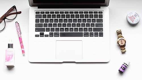 watch MacBook Pro near pen keyboard