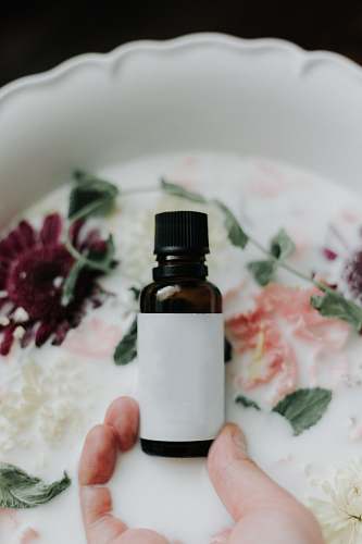 person white and black glass bottle milk