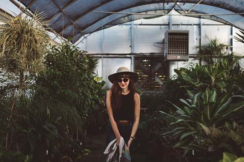  woman standing in between plants 