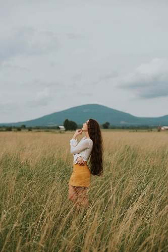 person woman standing in the middle of grass field nature