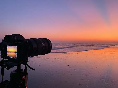 electronics black DSLR camera near body of water photo