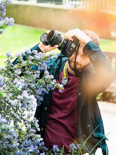 person man holding DSLR camera human