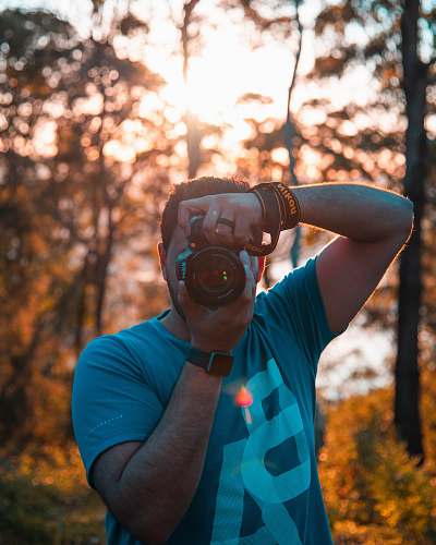 person man using DSLR camera human