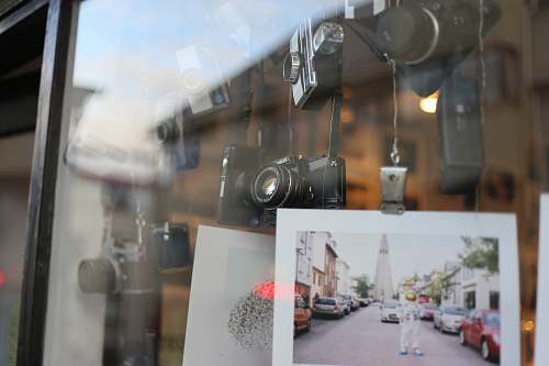 window photo of man wearing astronaut suit hanging near cameras electronics