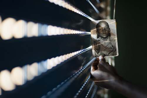 holding person holding a photo of boy in collared top photo