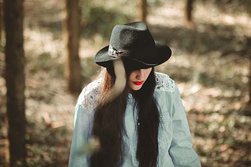apparel woman wearing blue long-sleeved shirt and black fedora hat clothing