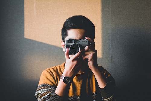 person man holding camera camera