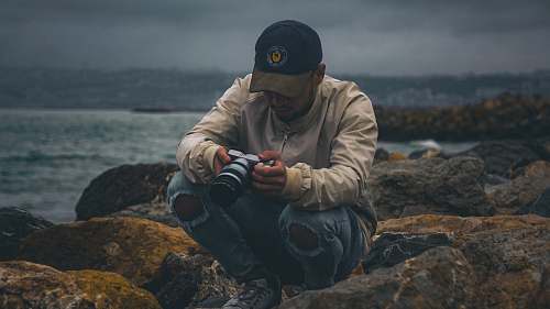 person man sitting on rock apparel