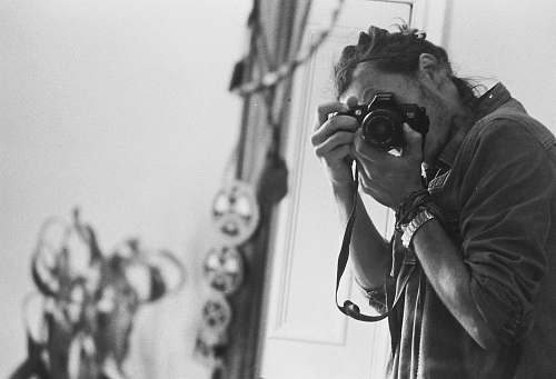 black-and-white man taking photo grey