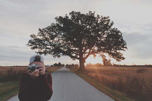 person man taking photos using gray DSLR camera people