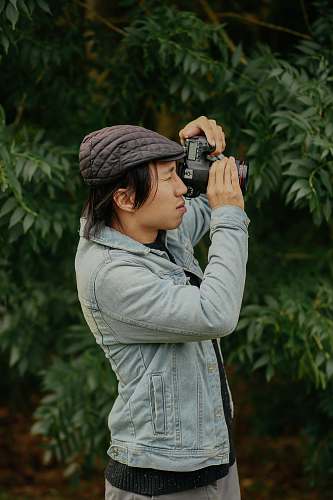 person man wearing grey jacket taking picture photo