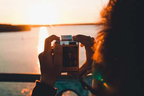 person person taking photo of sea camera