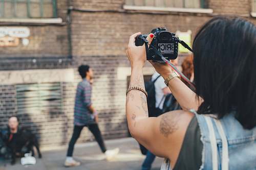 person person taking photo on concrete building people