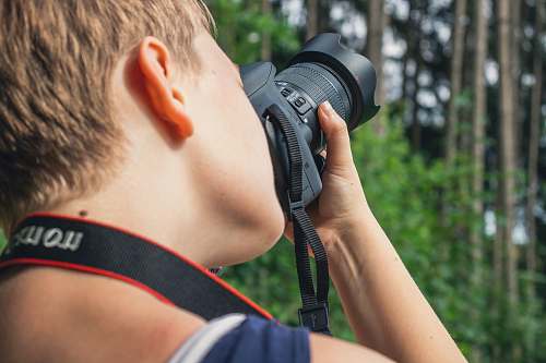 person person taking photo using camera camera