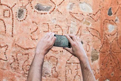 person person taking picture of wall phone