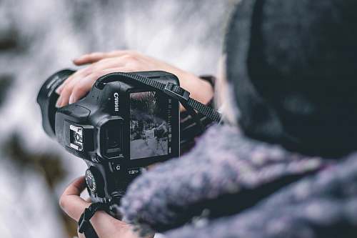 person selective focus photography of DSLR camera photography