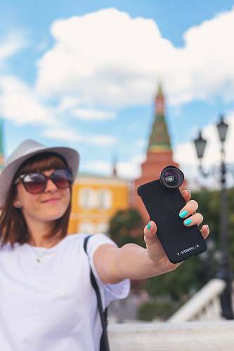 person woman holding black smartphone accessories