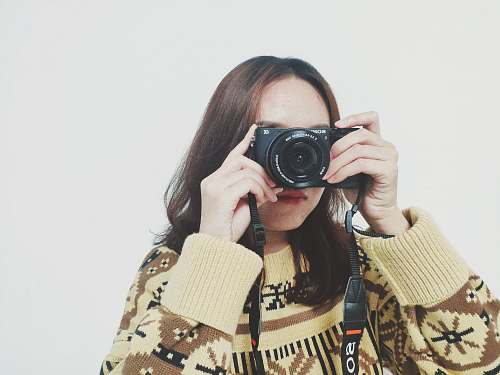 person woman holding camera camera