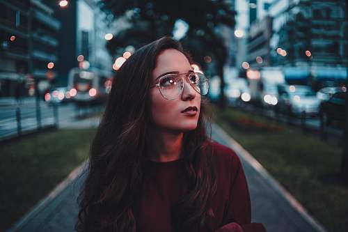person woman in maroon sweater with eyeglasses accessories