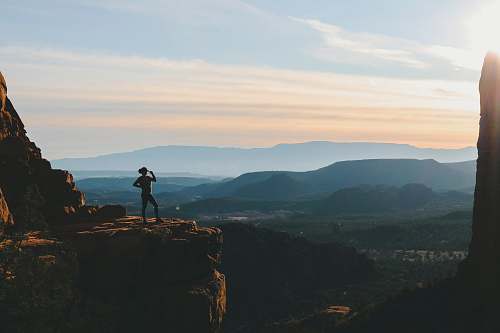 outdoors woman standing on cliff during sunset nature