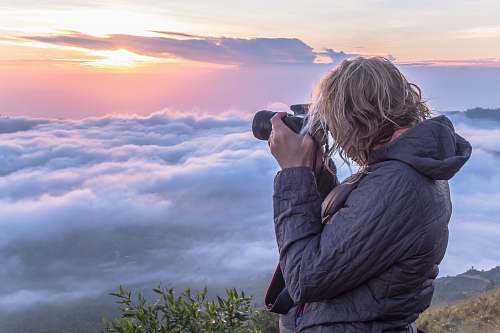 person woman taking photo of clouds mount batur