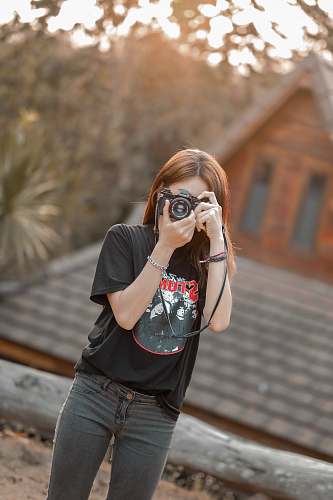 person woman with DSLR camera taking pictures accessories