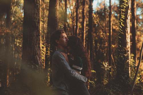 forest man and woman hugging each other on forest couple