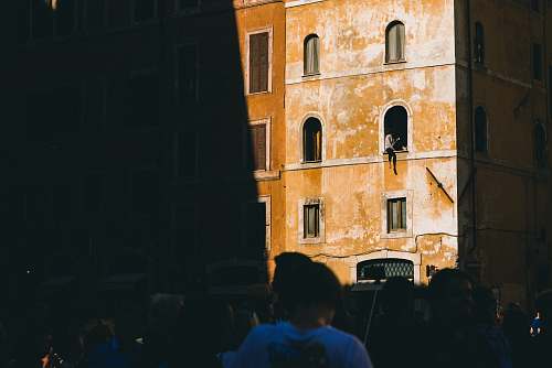 building person sitting on building window italy