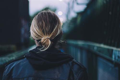 person woman wearing black jacket walking human