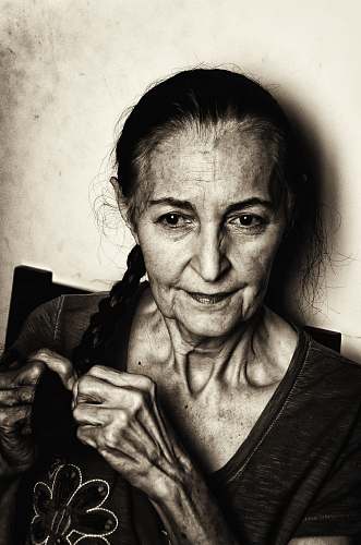 face grayscale photo of woman with braided hair human
