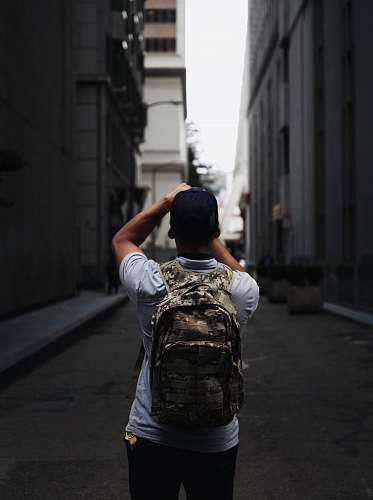 backpack man standing between two buildings urban