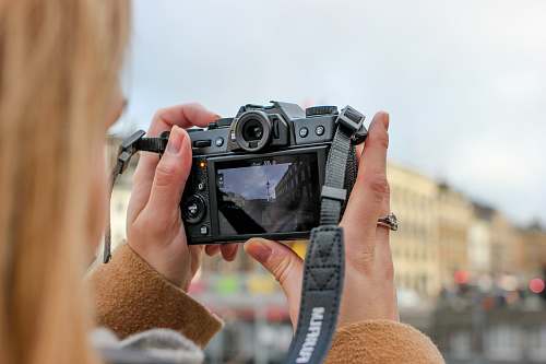 human person holding camera electronics