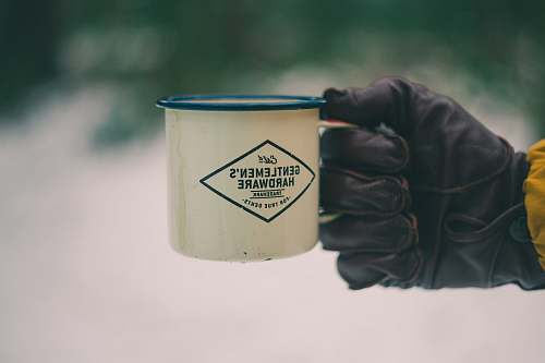 human person holding white ceramic mug people