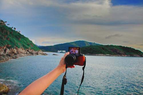 human wide-angle photography of mountain range and seashore during daytime camera