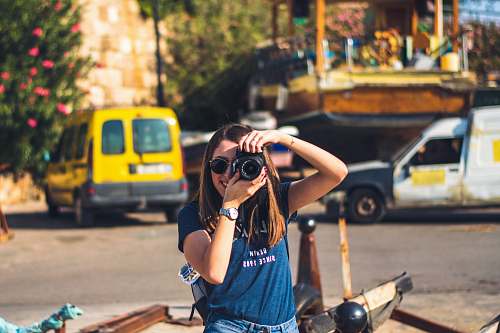 human woman holding DSLR camera accessories