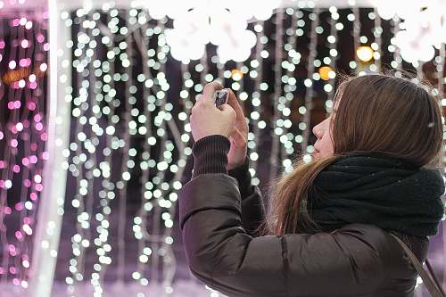 girl woman in black scarf using smartphone scarf