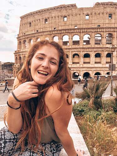 human woman smiling near coliseum face