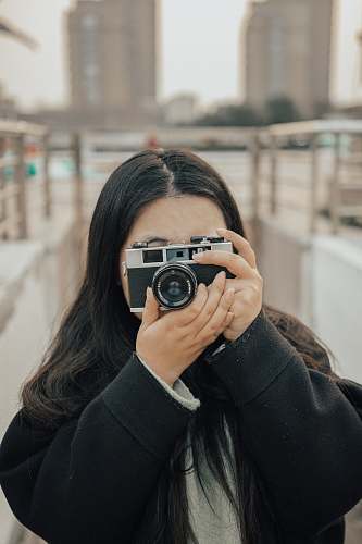 human woman wearing black camera camera