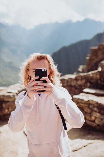 face woman wearing white sweater taking selfie human