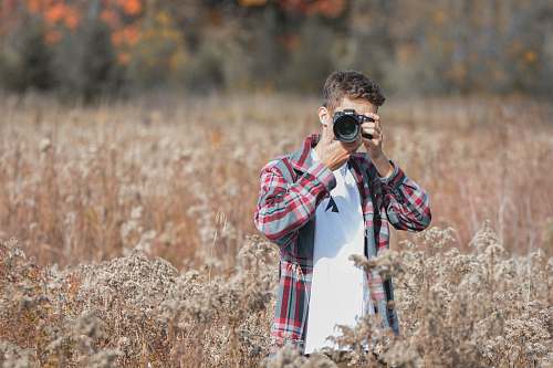 person man holding DSLR camera human