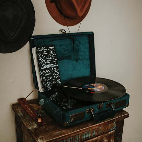rust black and blue turntable on brown wooden side table record
