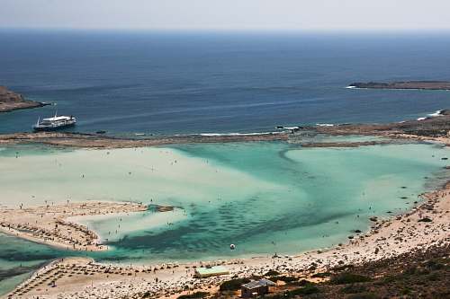 ocean aerial photography of island near shore water