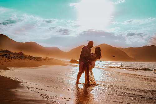 water couple walking in seashore ocean