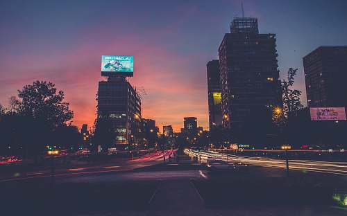 building city buildings during sunset cars