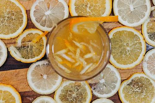 fruit full drinking glass surrounded with lemon slices citrus fruit