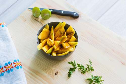 plant sliced fruits in bowl on wooden chopping board fruit