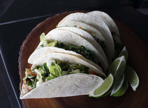 tacos tacos on brown wood slab taco