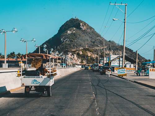 mazatlan white auto rickshaw on riding on asphalt road towards green mountain road