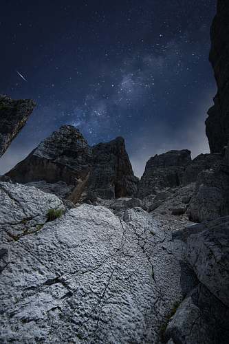 outdoors rocky mountain under blue sky during night time space