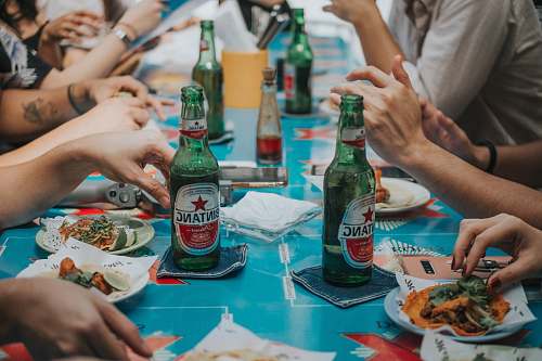 beer green beer bottles on blue coasters human